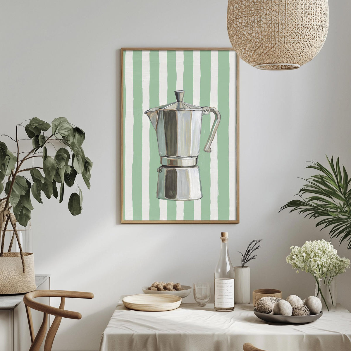 a dining room with a framed picture of a silver coffee maker on the wall, a table set with plates, bowls, and a bottle, and various potted plants and vases around the room.