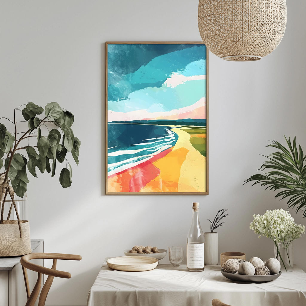 a dining table with a white tablecloth, a vase of white flowers, a bottle of wine, and a bowl of fruit. Above the table, there is a framed painting depicting a beach scene with a colorful sky and ocean.