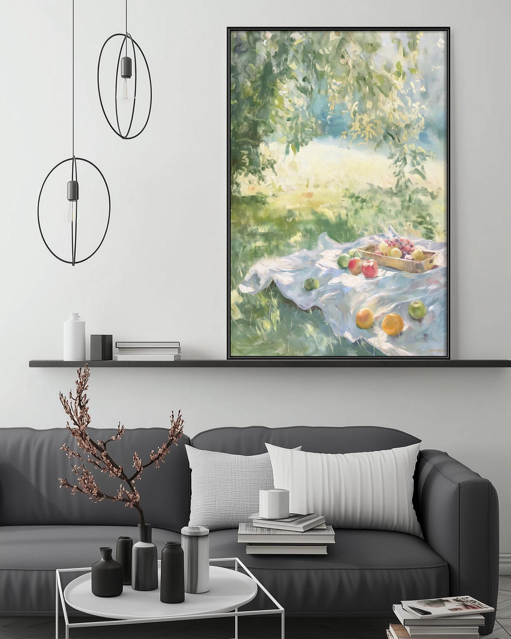 a living room with a gray sofa, a coffee table, and a large painting of a fruit basket on a blanket hanging on the wall above the sofa.