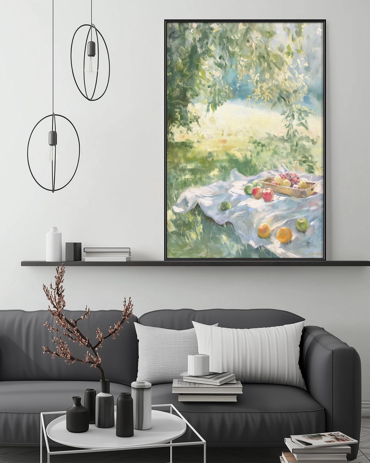 a living room with a gray sofa, a coffee table, and a large painting of a fruit basket on a blanket hanging on the wall above the sofa.