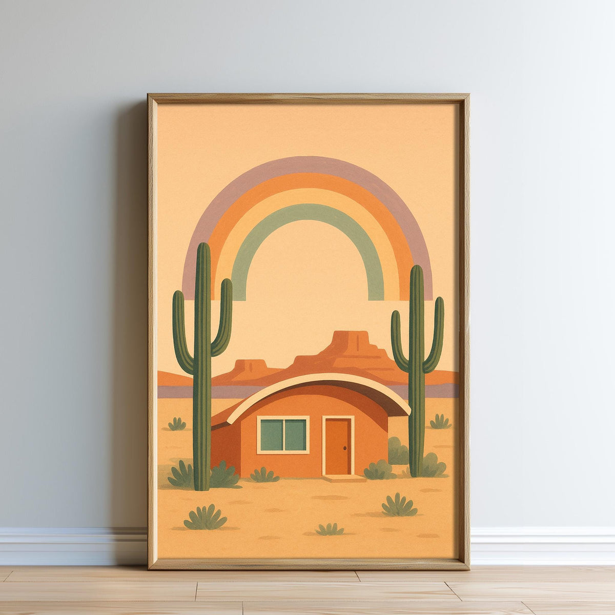 The image is a framed illustration depicting a desert scene with a small house, cacti, and a rainbow in the background.