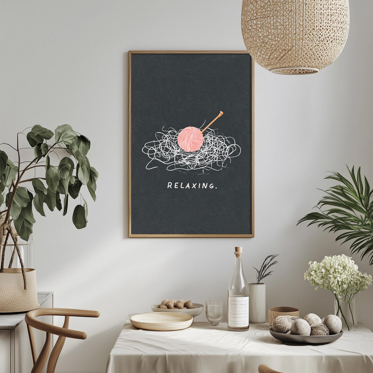 a dining table with a bowl of fruit, a bottle, and a vase of flowers, along with a framed poster on the wall that says "Relaxing."