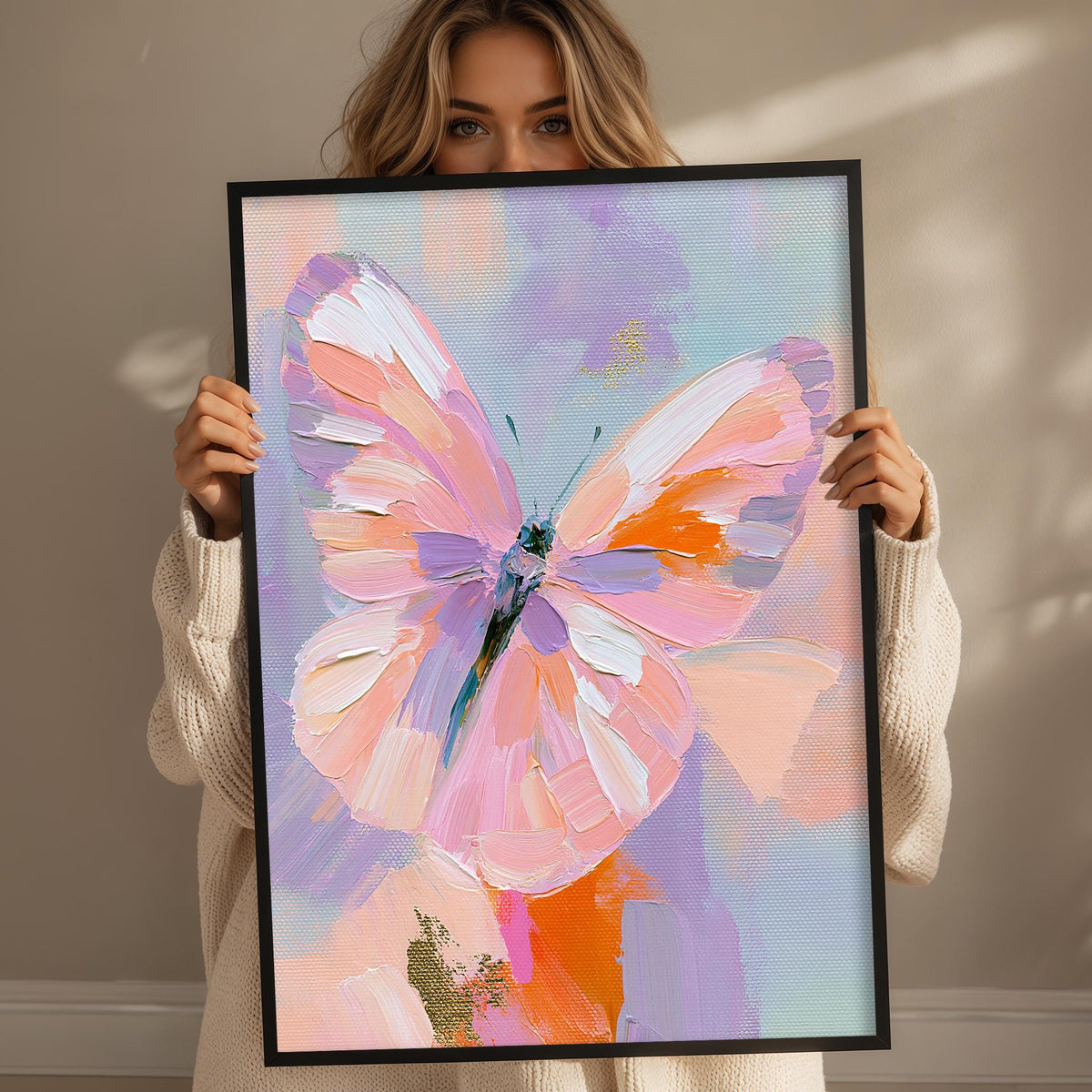 A woman holds up a framed painting of a colorful butterfly against a light background.