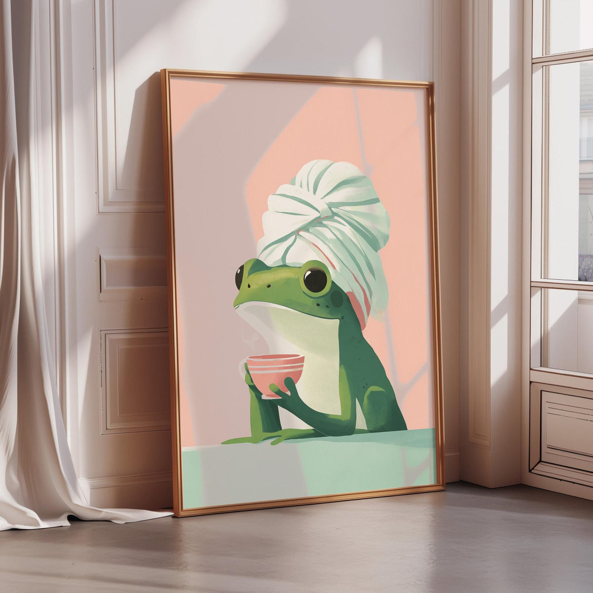 A framed illustration of a green frog wearing a white towel and holding a pink cup, sitting on a white surface.