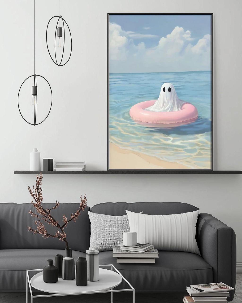 a cozy living room with a gray sofa, a coffee table, and a large framed painting of a ghost floating on a pink inner tube in the ocean.