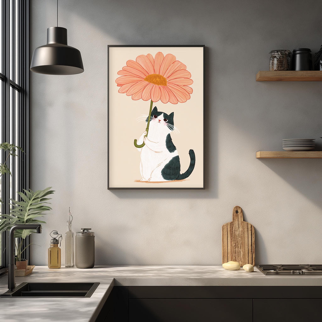 a kitchen counter with a framed illustration of a cat holding a large pink flower, which is hanging on the wall above the counter.
