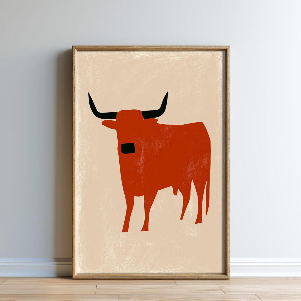 a framed artwork depicting a red bull with horns.