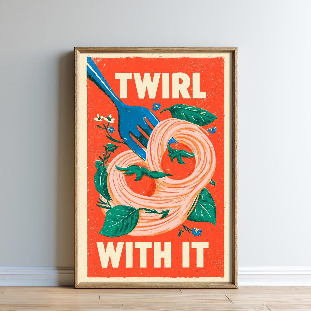 The image is a framed poster with a vibrant design featuring a blue fork, a spiral of noodles, and various colorful elements such as leaves and flowers. The text on the poster reads "TWIRL WITH IT".
