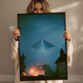 A woman holds up a framed image of a triangular object with lights, which appears to be a UFO or unidentified flying object, against a backdrop of a house and trees.