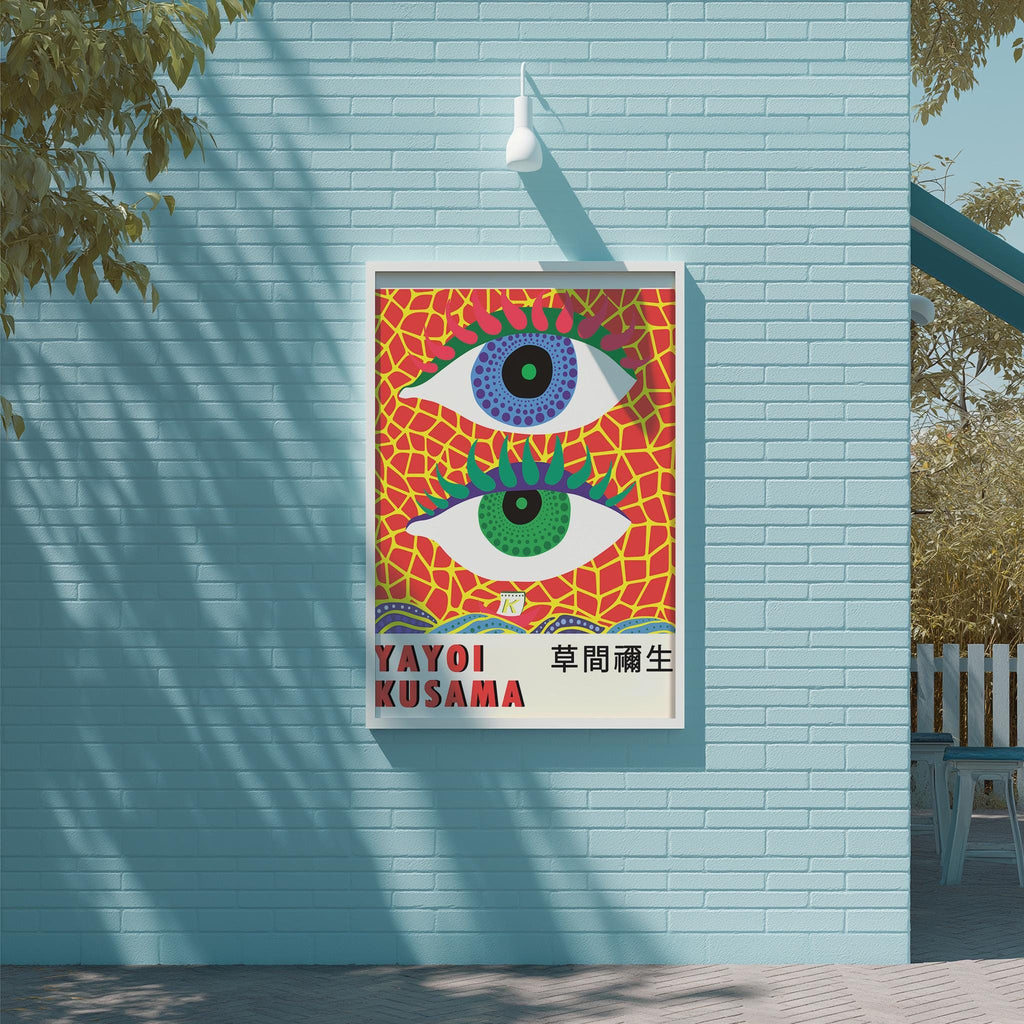 A colorful poster featuring a large eye design with a red and yellow background and a white border, hanging on a light blue wall.
