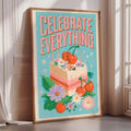 a framed poster with a colorful illustration of a cake surrounded by flowers and cherries, along with the text "CELEBRATE EVERYTHING" written on it.