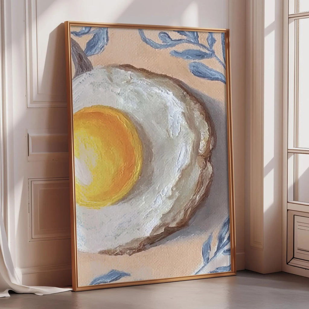 a large painting of an egg on a white background, with a yellow yolk and a brown crust. The painting is framed and placed on a wooden floor in a room with a window.