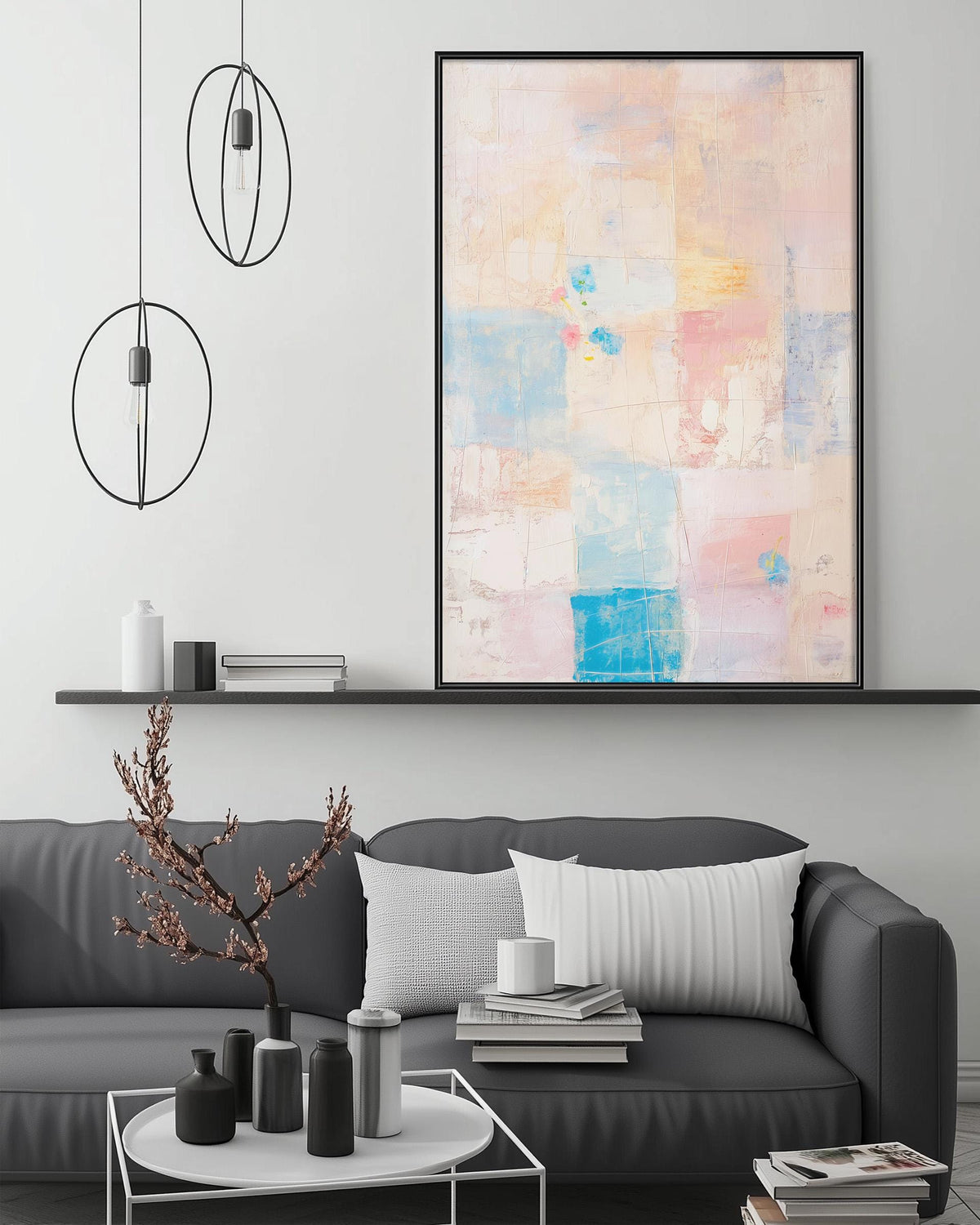 a modern living room with a gray sofa, a coffee table, and a large abstract painting hanging on the wall above the sofa.