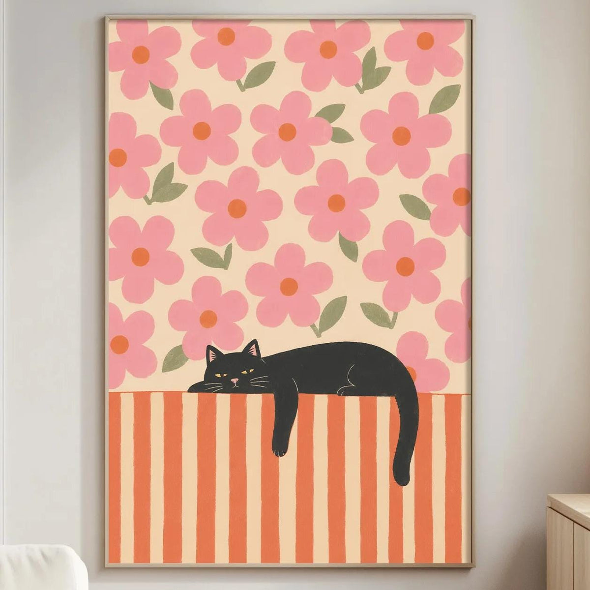 a living room with a large framed poster of a black cat resting on a striped orange and white surface, which is hanging on the wall.
