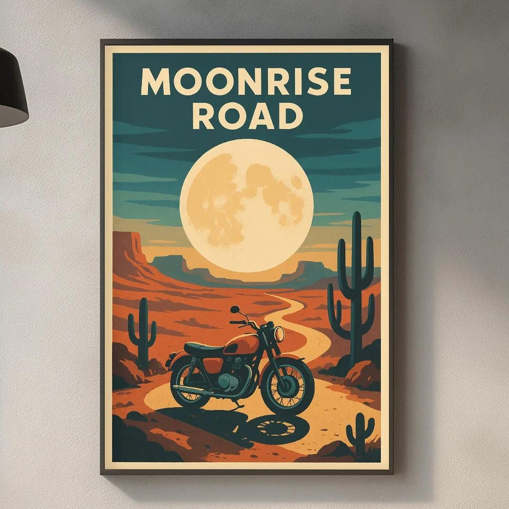 a framed poster of a desert scene with a motorcycle, cacti, and a large moon, hanging on a wall above a kitchen counter.