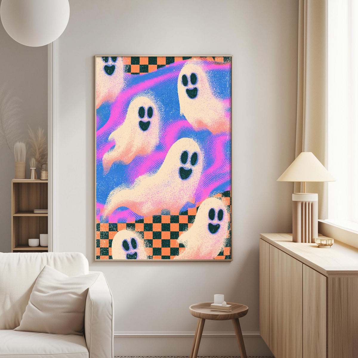 a living room with a large, colorful painting of ghostly figures on the wall. The painting is a vibrant mix of pink, blue, and orange colors, with the ghostly figures appearing to float and dance across the frame. The room is furnished with a white couch and a wooden side table, creating a cozy and inviting atmosphere.