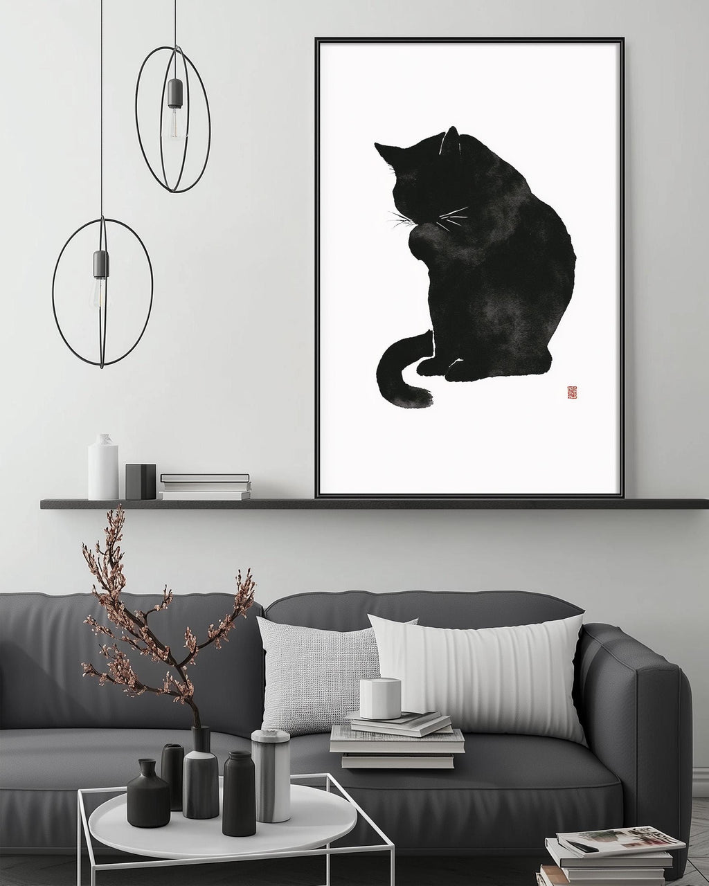 a black and white cat sitting on a couch, with a framed print of the cat above it. The room has a minimalist and modern design, with a gray couch, a coffee table, and a shelf with decorative items.