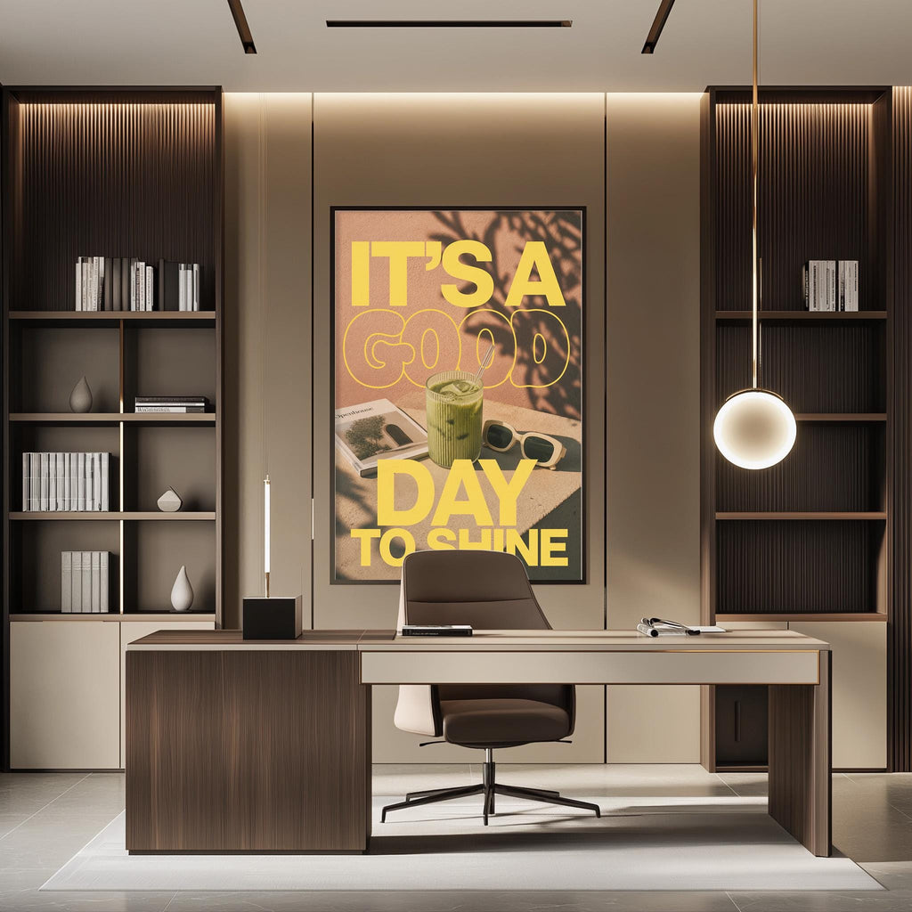 a modern office space with a large poster on the wall that reads "IT'S A GOOD DAY TO SHINE". The office has a wooden desk, a chair, and a bookshelf. The overall design and decor of the space create a professional and stylish atmosphere.