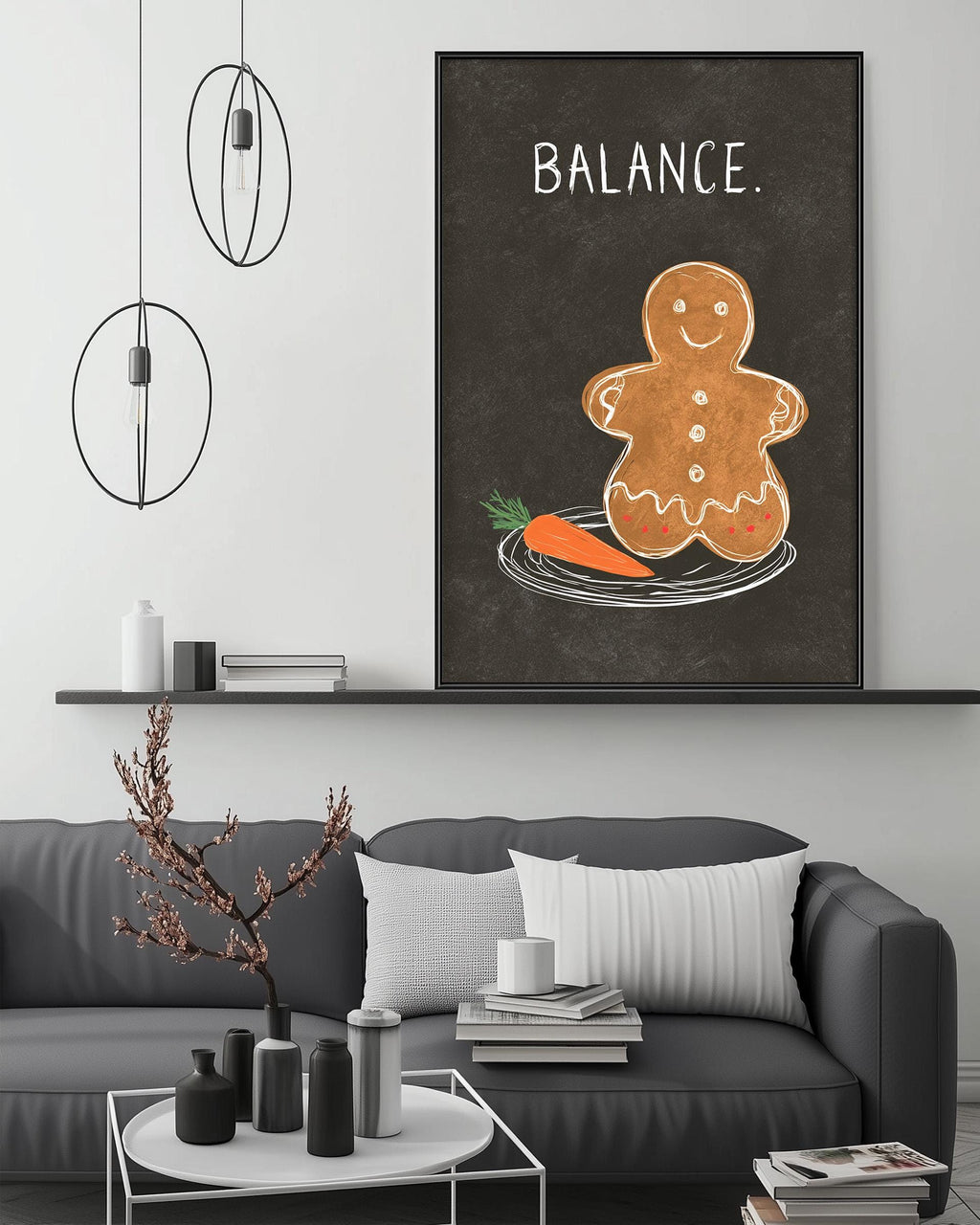 a cozy living room with a gray couch, a coffee table, and a large framed poster of a gingerbread man on the wall. The poster has the word "BALANCE" written on it.