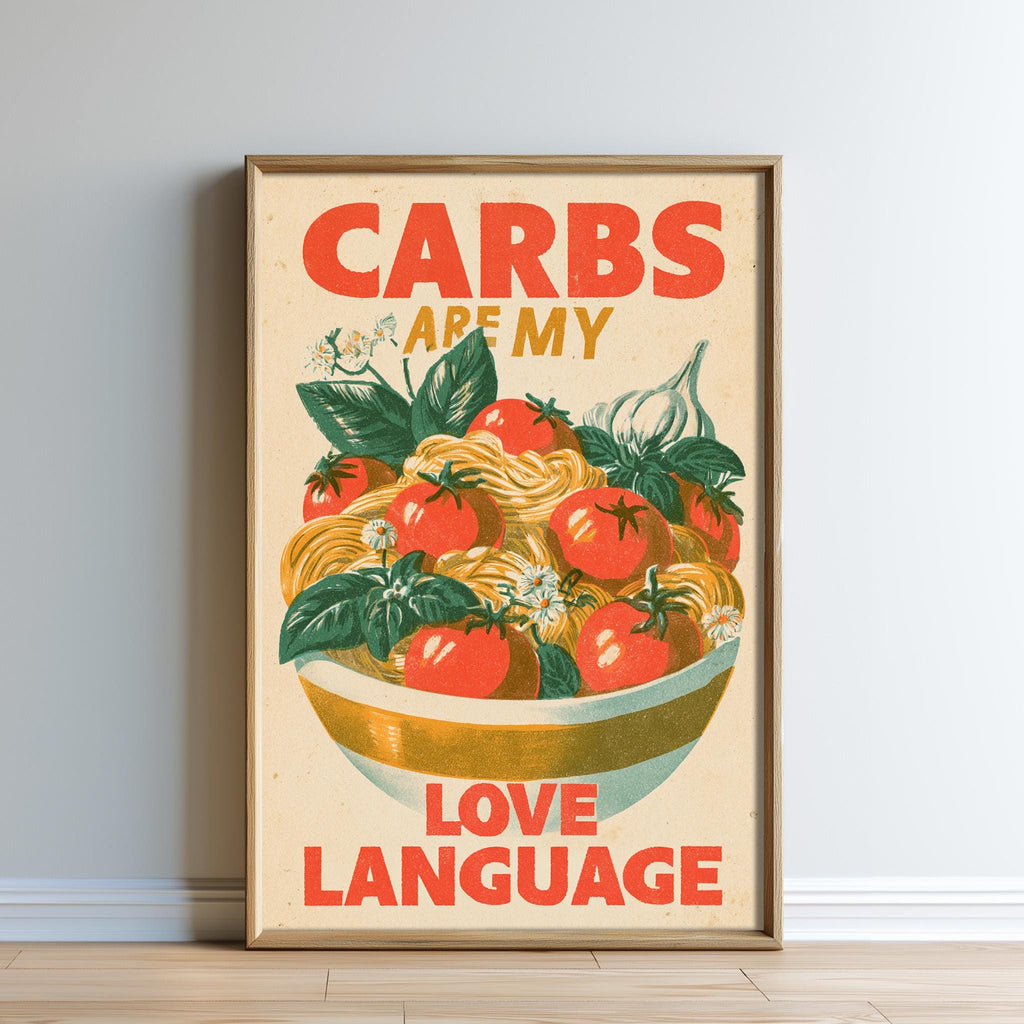 The image is a framed poster with a vibrant illustration of a bowl of pasta and tomatoes, accompanied by the text "CARBS ARE MY LOVE LANGUAGE".