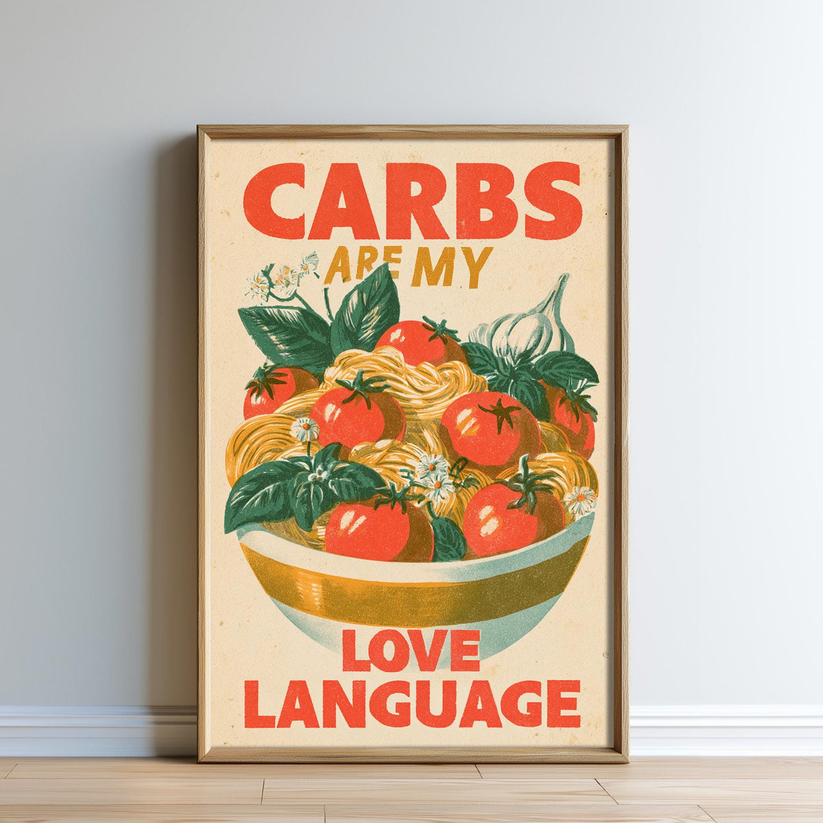 The image is a framed poster with a vibrant illustration of a bowl of pasta and tomatoes, accompanied by the text "CARBS ARE MY LOVE LANGUAGE".