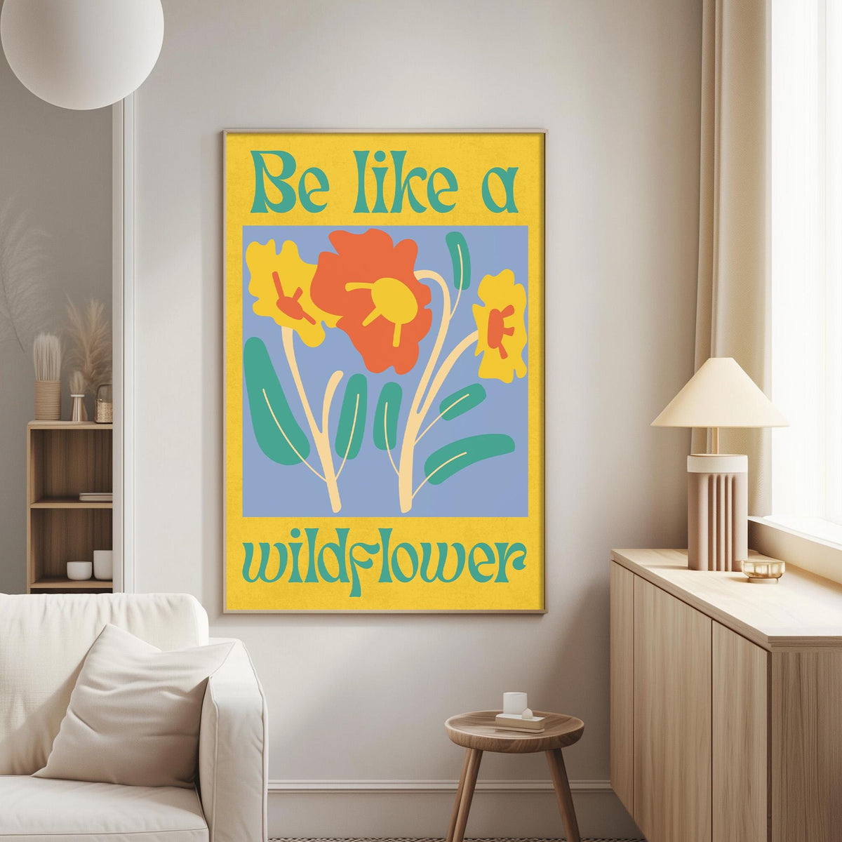 a living room with a large yellow poster on the wall that says "Be Like a Wildflower".