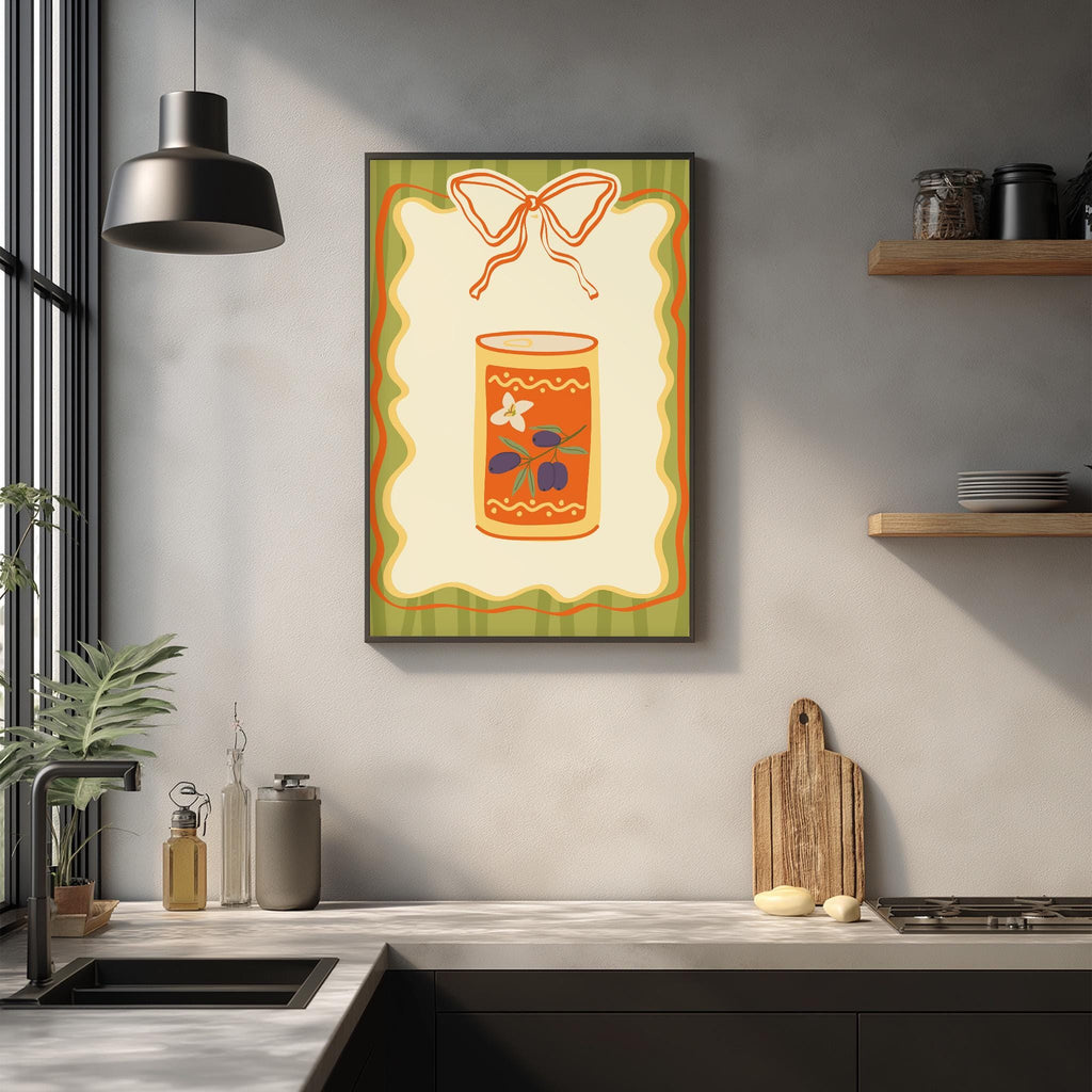 a kitchen counter with various kitchen items, including a cutting board, a soap dispenser, and a plant. Above the counter, there is a framed picture of a can of food with a bow on top.