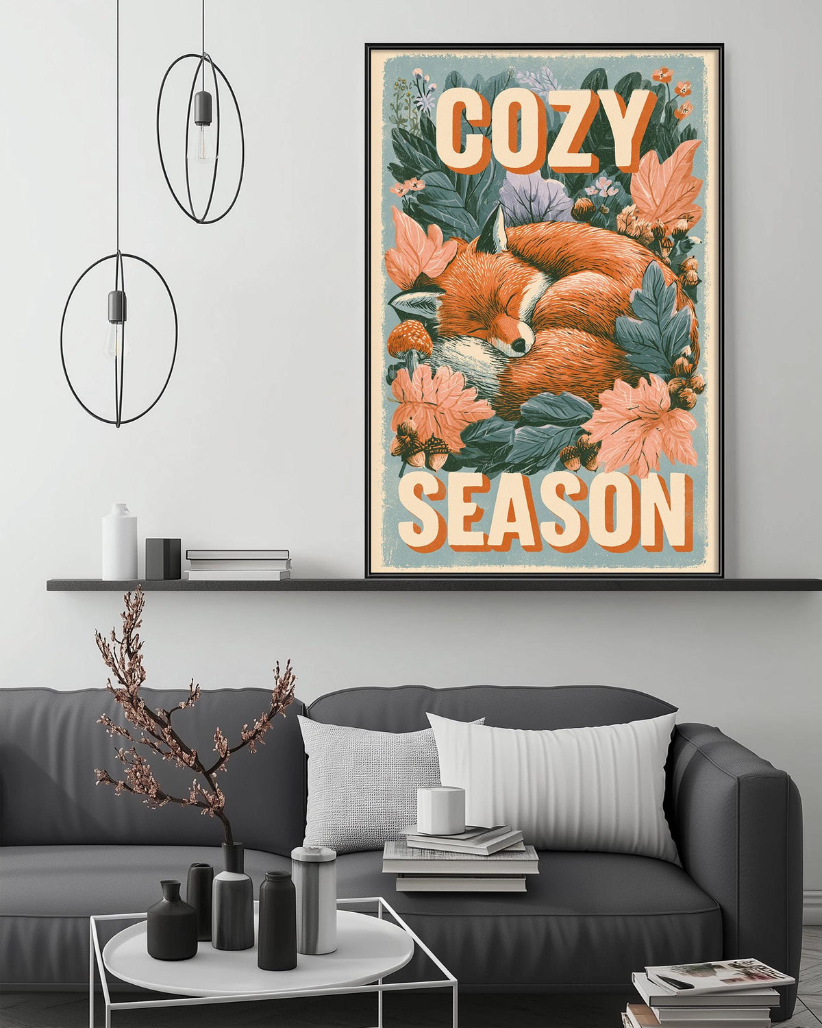 a cozy scene with a framed poster of a sleeping fox surrounded by flowers and leaves, hanging on a wall above a gray couch. The poster has the text "COZY SEASON" written on it.