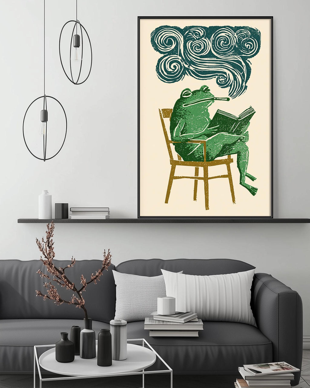 a cozy living room with a gray sofa, a coffee table, and a framed illustration of a green frog sitting in a chair and reading a book.
