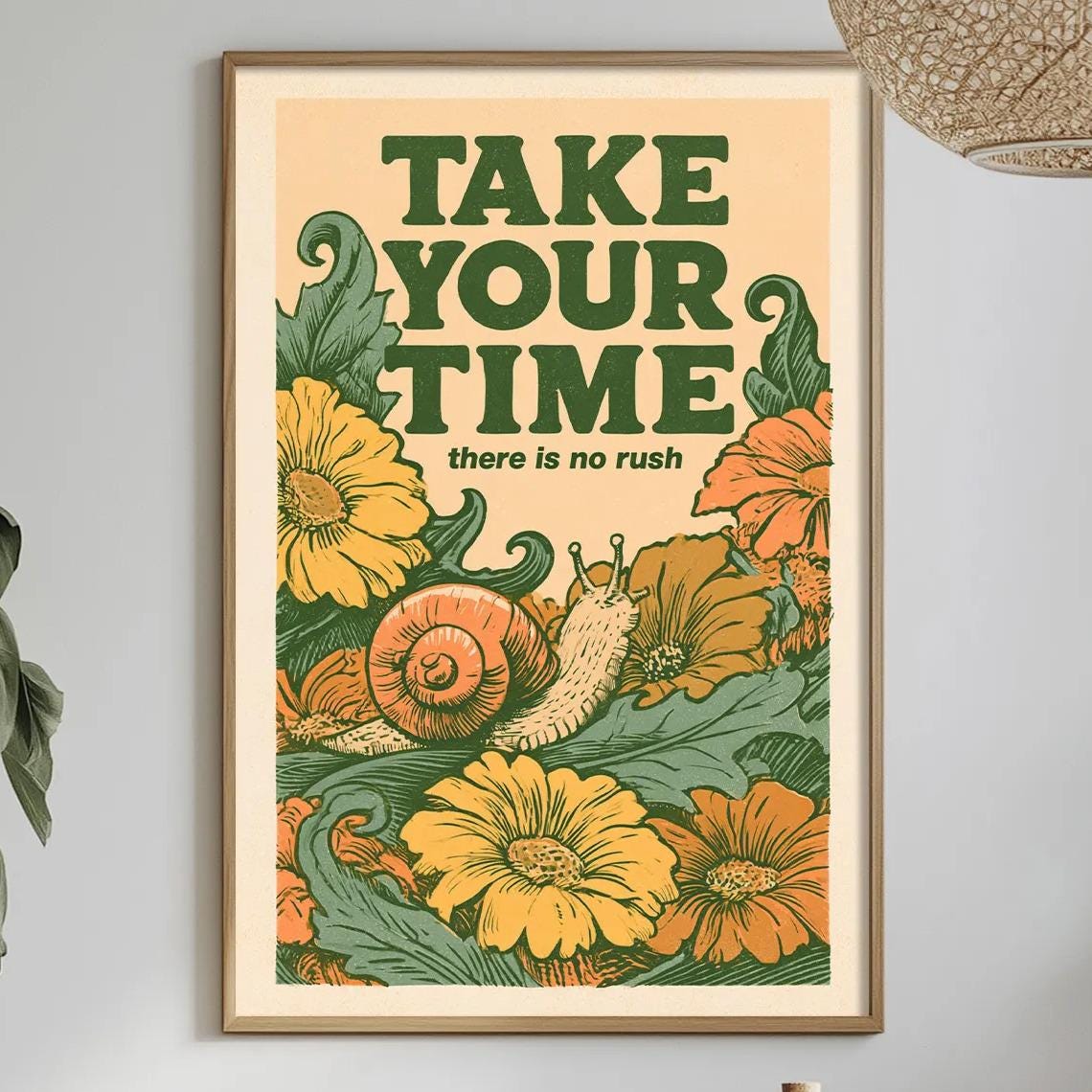 a framed poster with a vibrant illustration of flowers and a snail, hanging on a wall above a dining table with various items on it.