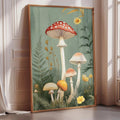 a framed painting of various mushrooms and plants, including a red-spotted mushroom, a yellow mushroom, and a plant with yellow flowers, all set against a green background.