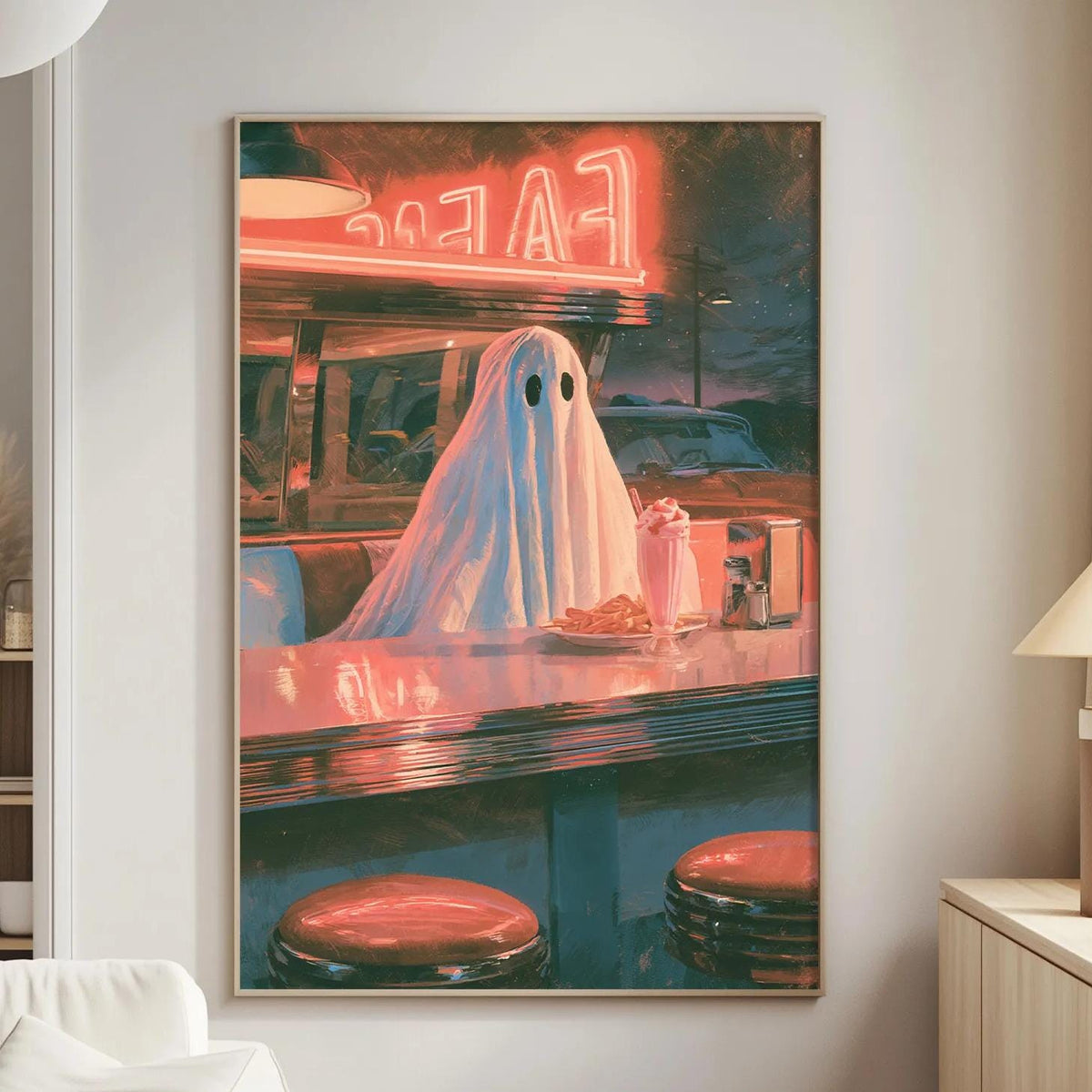 a large framed poster of a ghost sitting at a diner counter, with neon signs and a retro diner atmosphere.