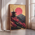A framed painting depicting a pagoda silhouetted against a vibrant sunset landscape with mountains and pink flowers.
