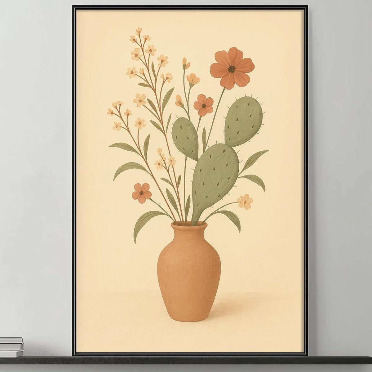 a living room with a gray sofa, a coffee table, and a large framed print of a cactus plant with flowers hanging above it. The room has a minimalist and modern design, with a black and white color scheme.