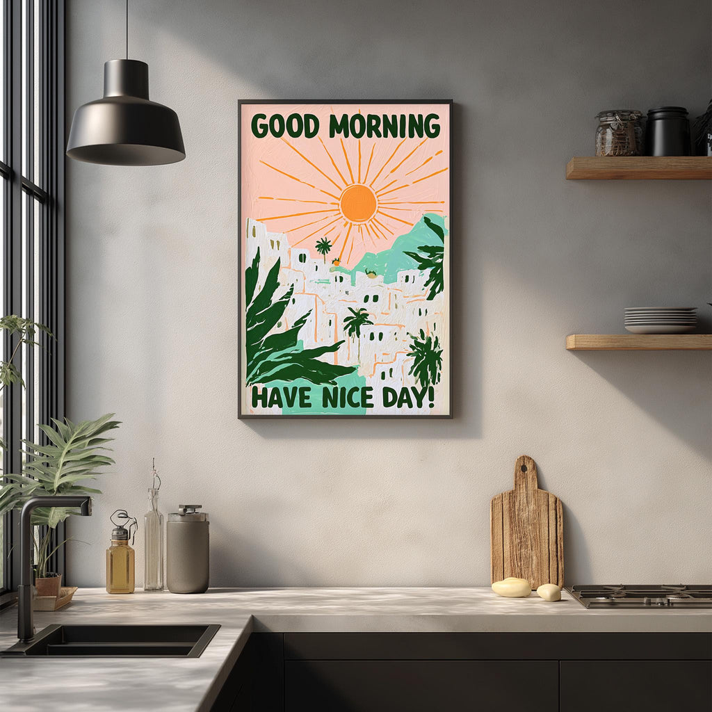 a kitchen counter with a framed poster hanging on the wall above it. The poster has a tropical landscape with palm trees and a sun, along with the text "GOOD MORNING HAVE NICE DAY!"