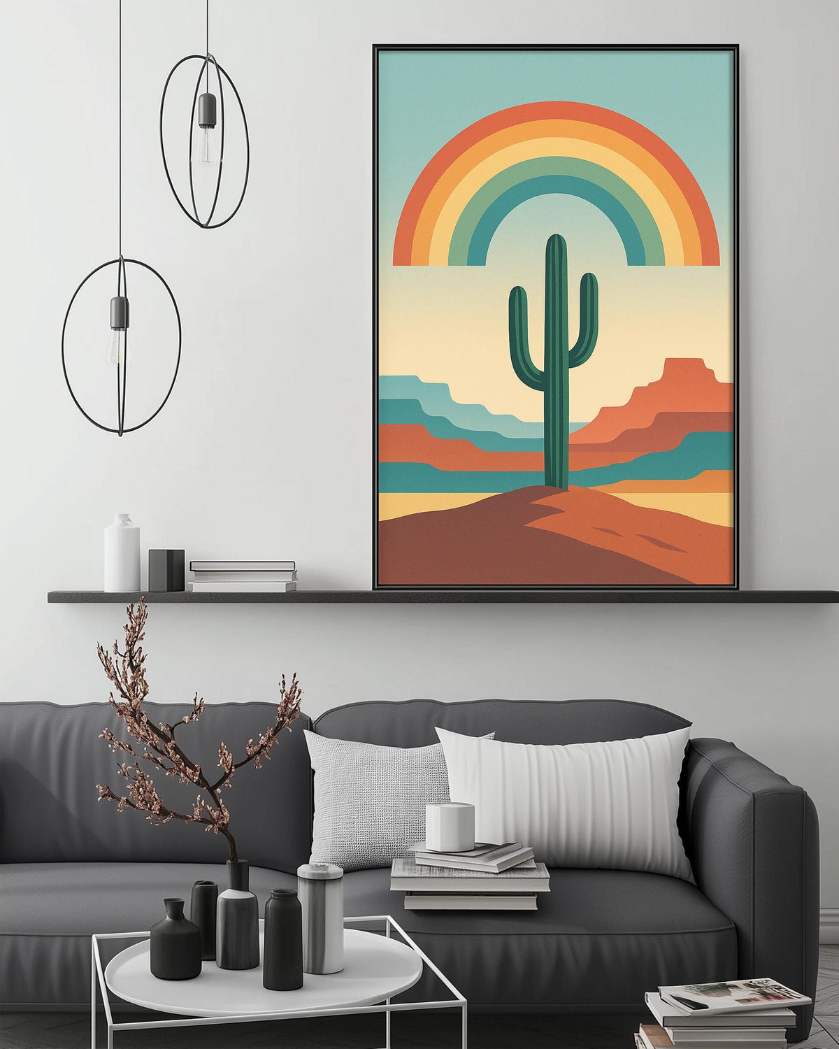 a modern living room with a gray sofa, a coffee table, and a framed poster of a desert landscape with a cactus and a rainbow above it.