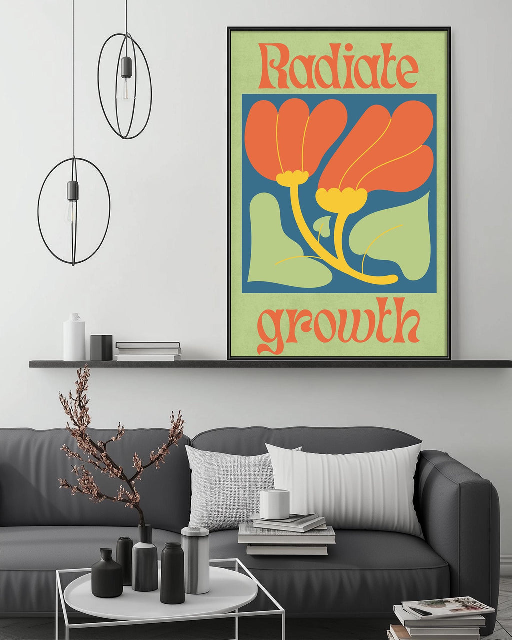 a living room with a gray couch, a coffee table, and a large framed poster with a floral design hanging on the wall above the couch.