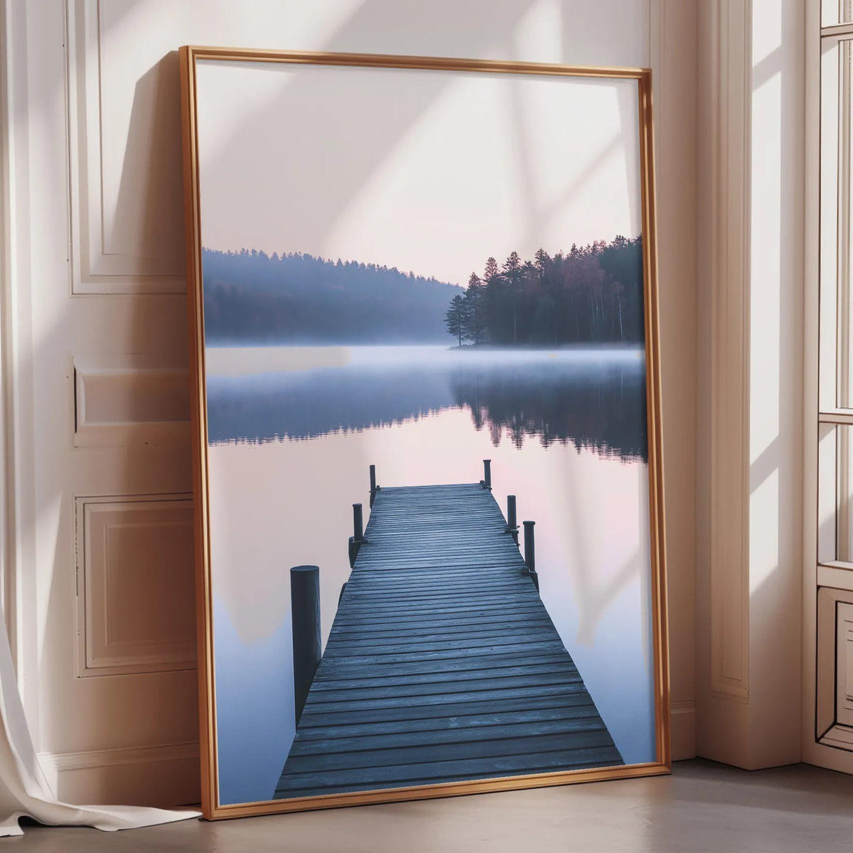 A large framed picture depicting a wooden dock leading to a serene lake surrounded by trees, with a hazy, misty atmosphere.