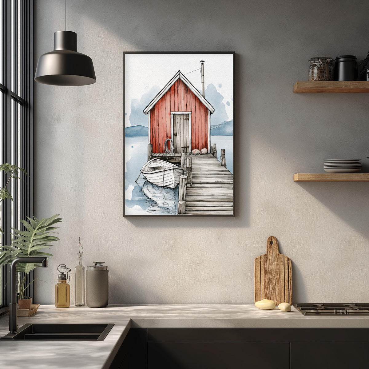 a kitchen scene with a framed illustration of a red wooden cabin with a dock and a boat on the water, hanging on the wall above a countertop with various kitchen items.