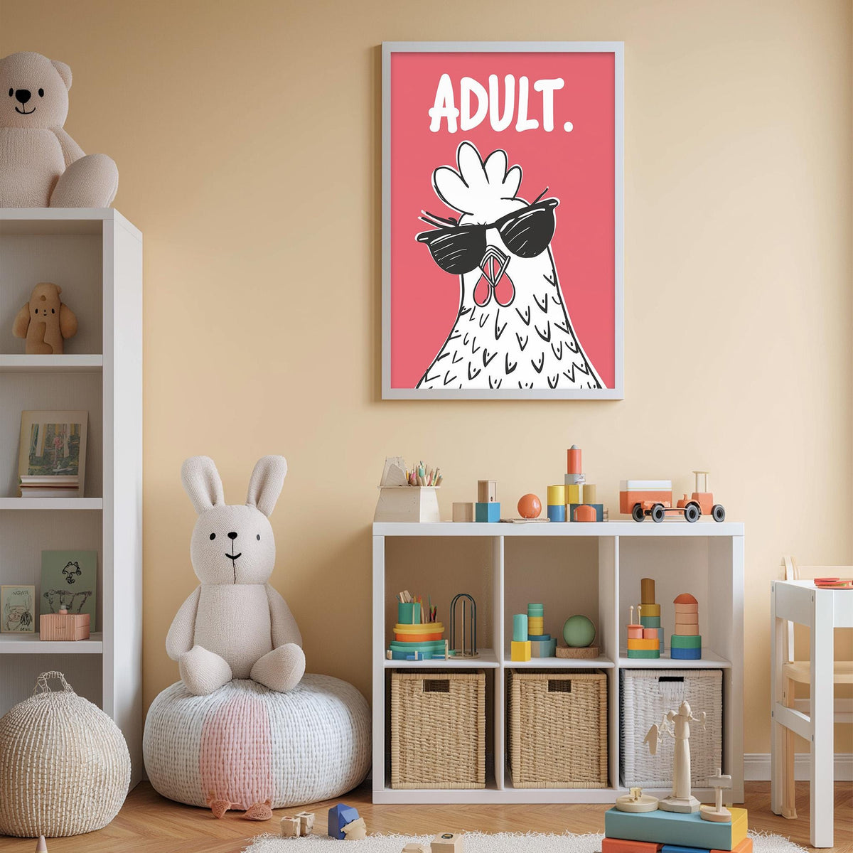 A child's bedroom with a white bookshelf, a stuffed rabbit, and a colorful toy box. Above the bookshelf is a framed poster with a cartoon chicken wearing sunglasses and the word "adult."