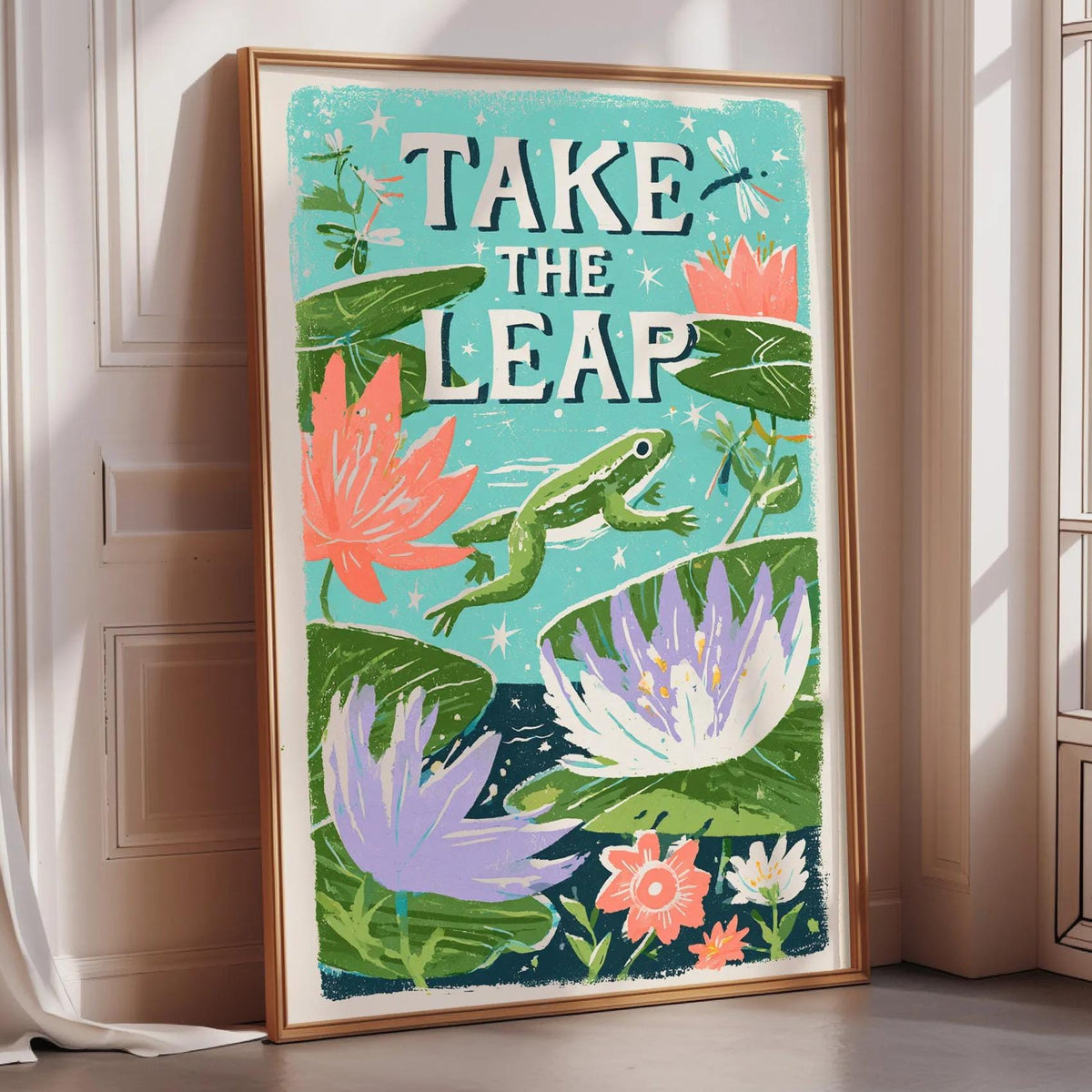 a framed poster with a vibrant illustration of a frog leaping over a pond filled with colorful flowers and plants.