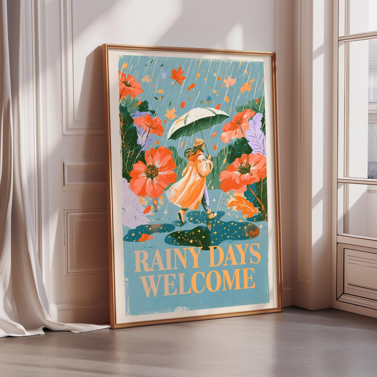The image is a framed poster with a woman holding an umbrella and walking through a garden with flowers. The poster has a blue background and the text "Rainy days welcome" written on it.