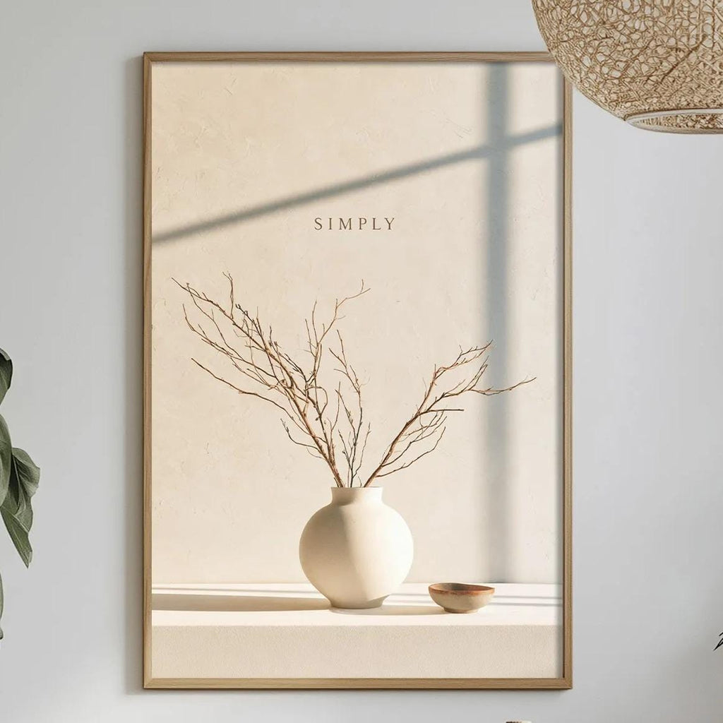 a minimalist dining room with a table set for two, a potted plant, a vase with flowers, and a framed picture of a vase with branches.