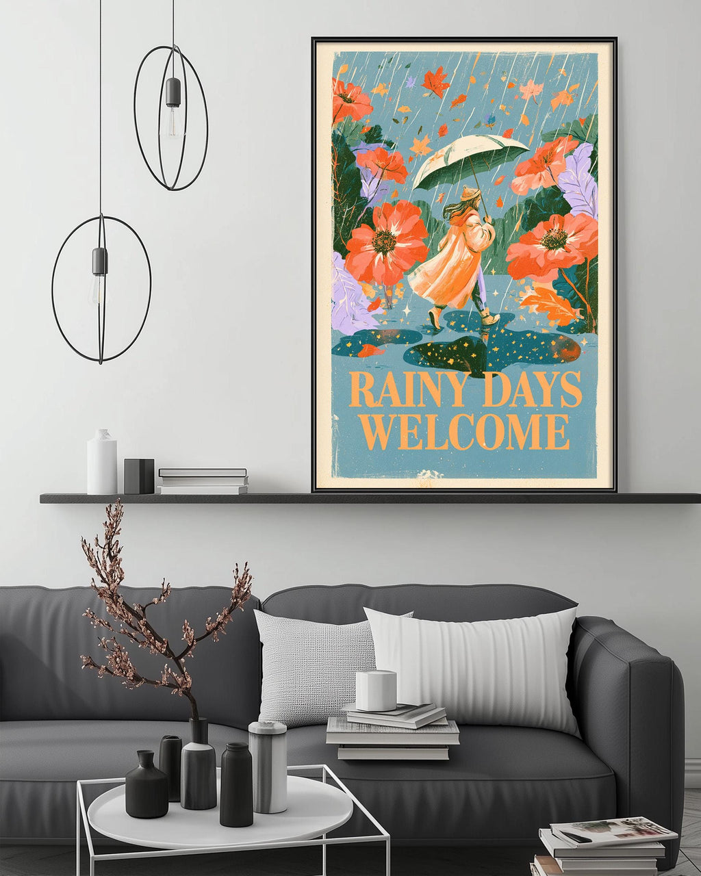 a cozy living room with a gray couch, a coffee table, and a framed poster of a woman holding an umbrella and surrounded by flowers. The poster has the text "Rainy days welcome" written on it.