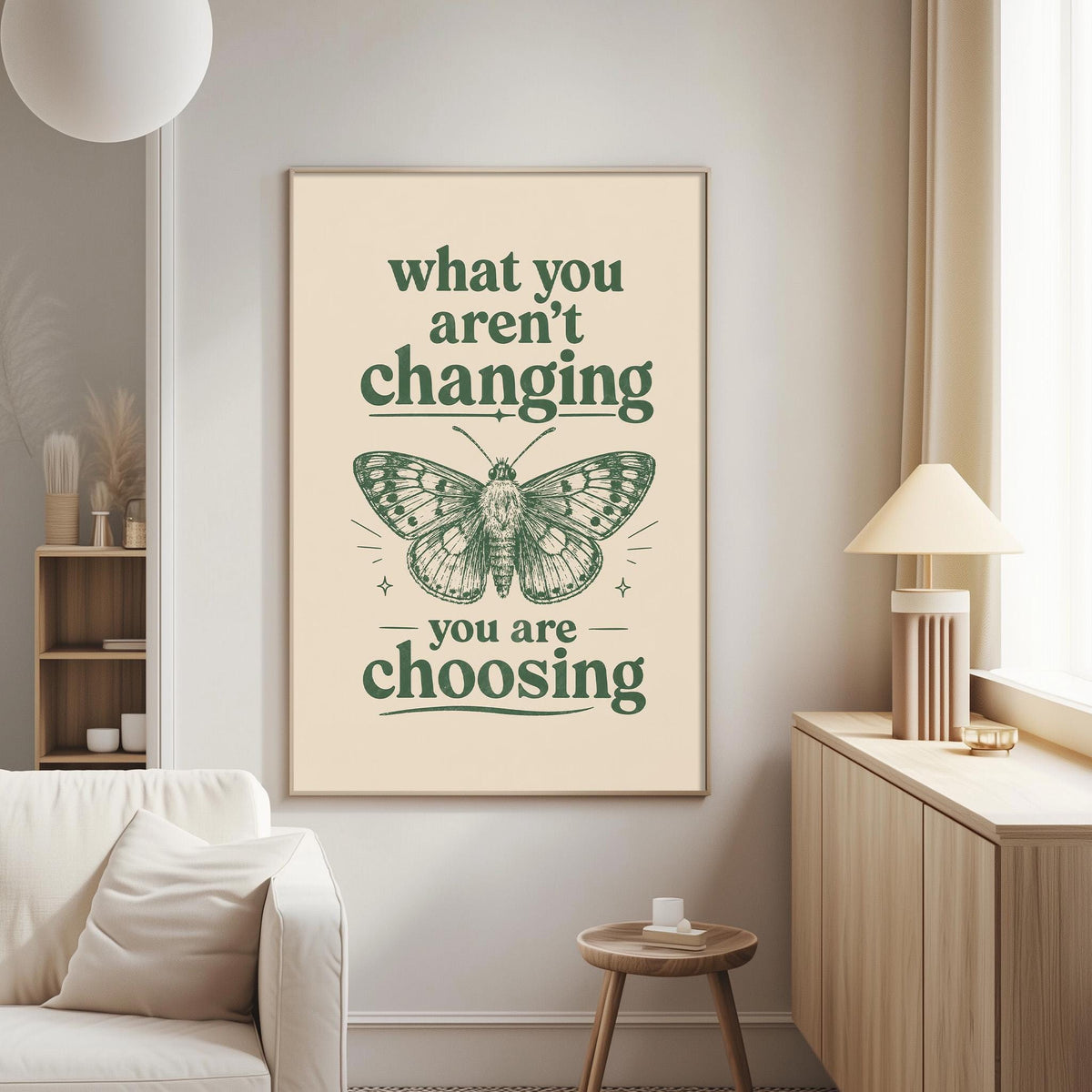 a poster with the text "what you aren't changing, you are choosing" and an illustration of a butterfly. The poster is displayed on a wall in a living room setting, with a white couch and a small table nearby.