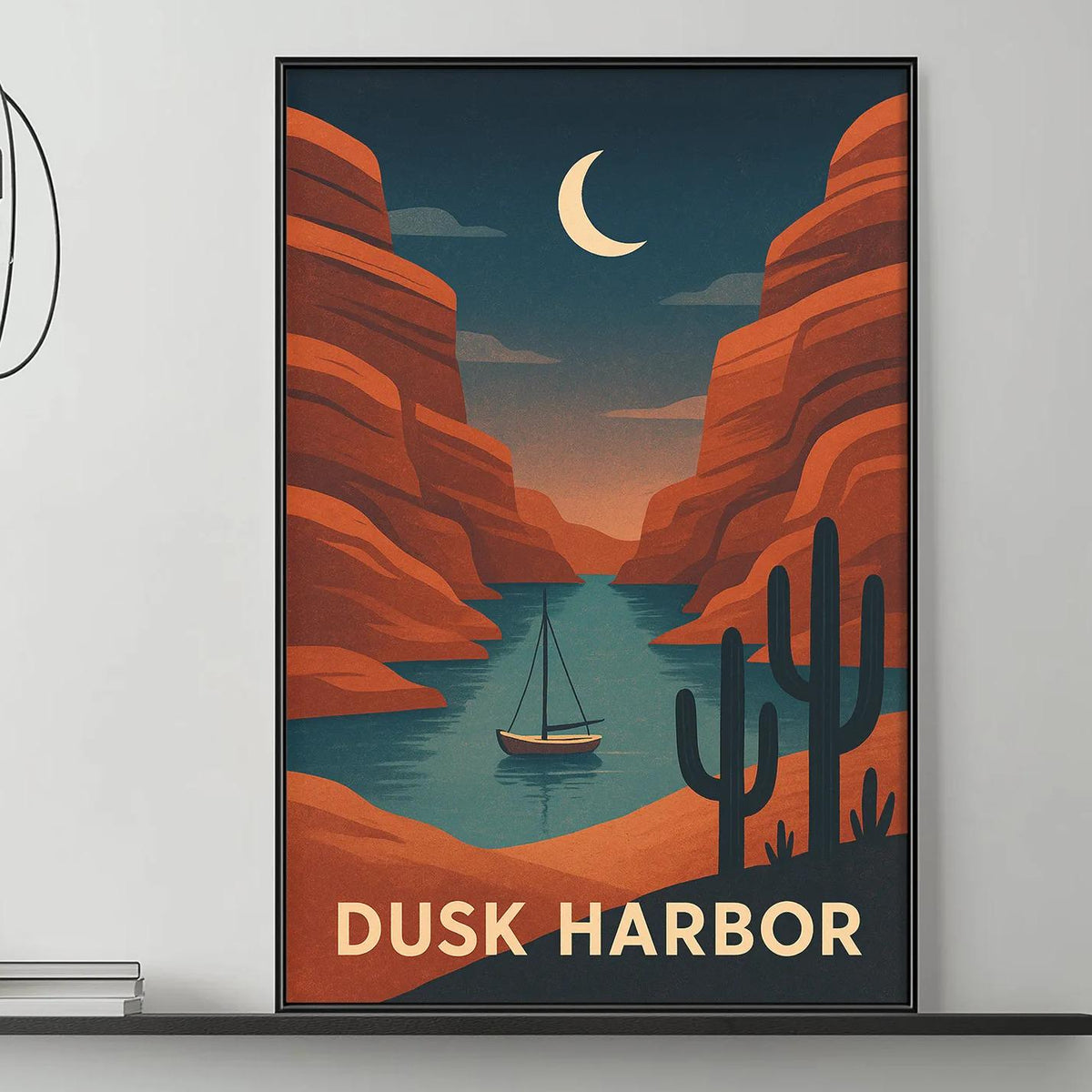 a modern living room with a gray sofa, a coffee table, and a framed poster of a desert landscape with a sailboat in the background.