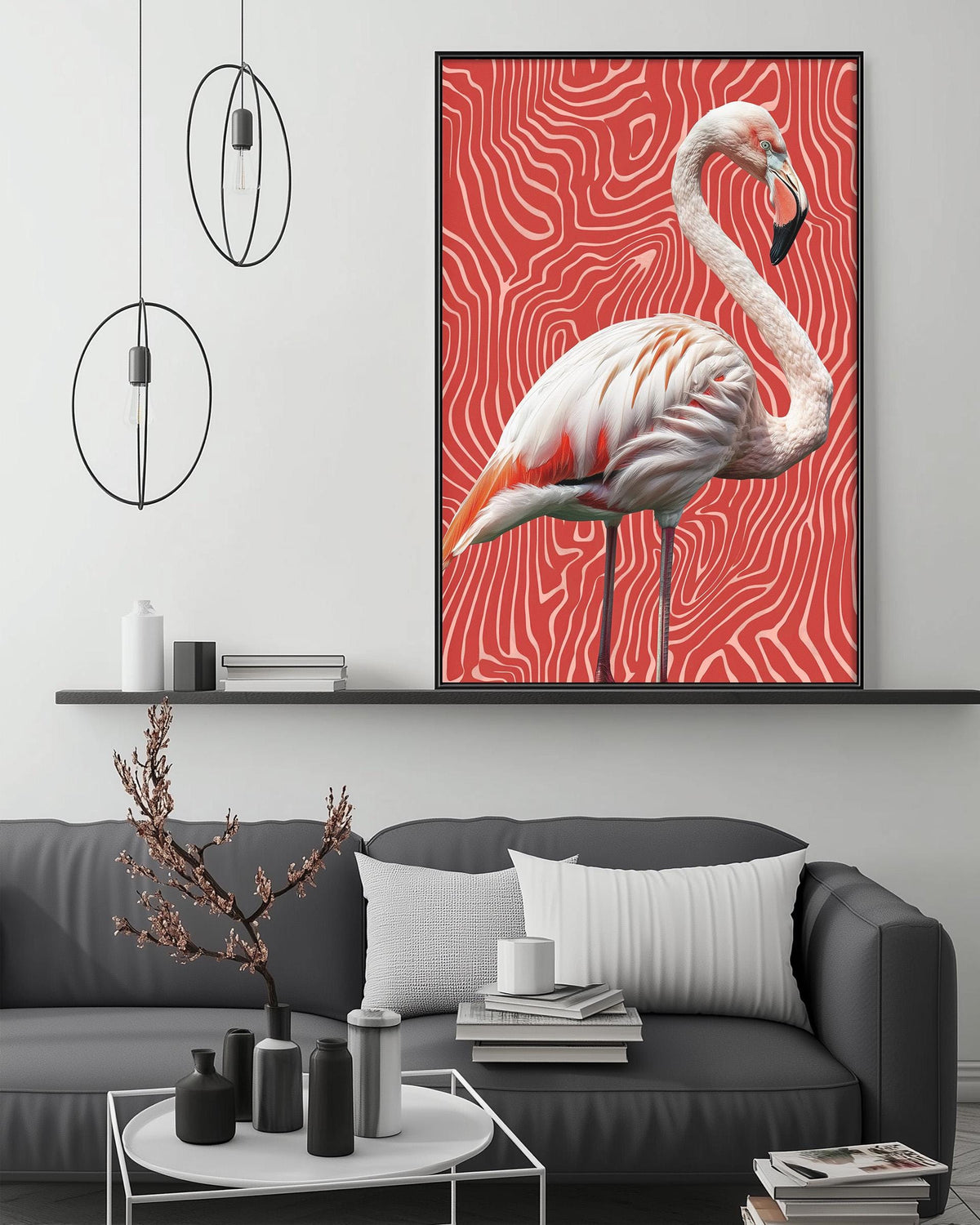 a large framed painting of a flamingo on a red and white striped background, hanging above a gray couch in a modern living room setting.