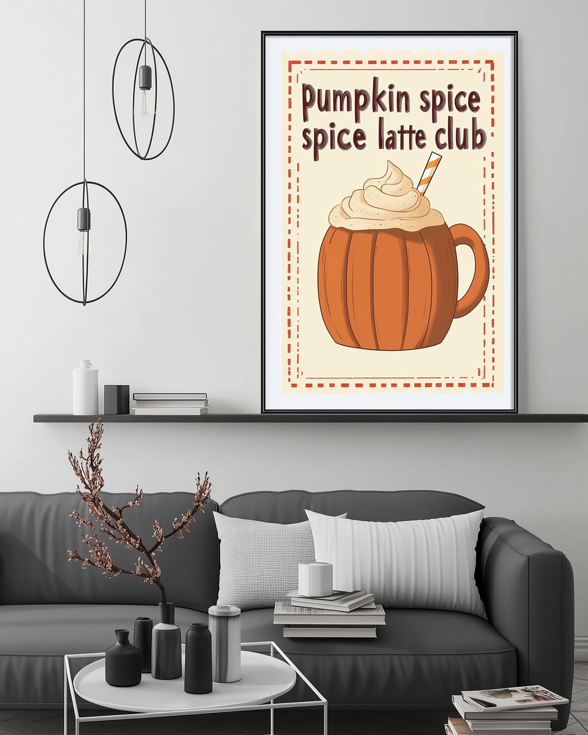 a cozy living room with a gray couch, a coffee table, and a framed poster of a pumpkin spice latte on the wall.