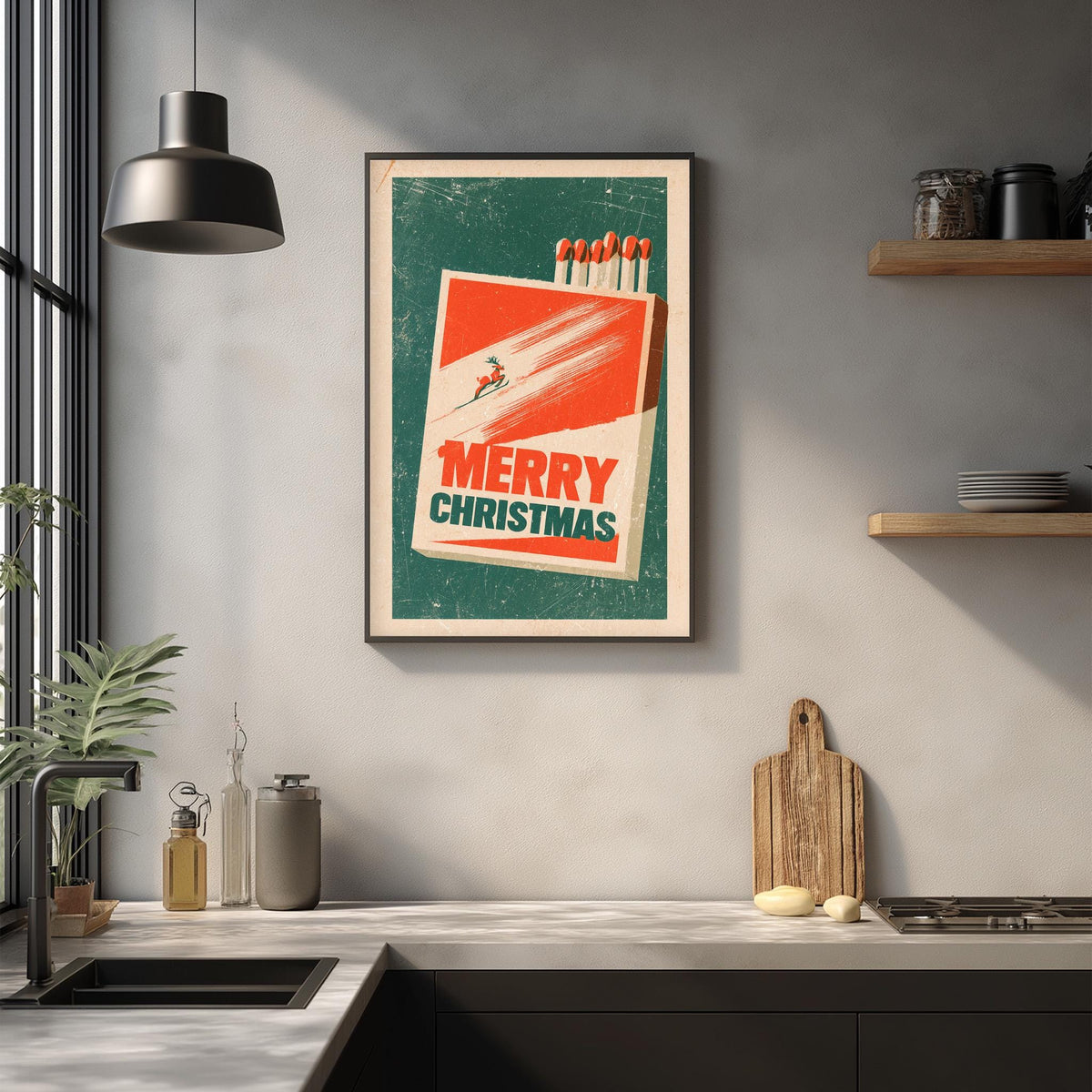 a kitchen counter with a framed poster of a matchbook with a "Merry Christmas" message, a wooden cutting board, and various kitchen items such as a bottle, a canister, and a bowl.