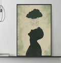 a living room with a gray sofa, a coffee table, and a large framed artwork depicting a silhouette of a person with a cloud above them. The artwork is hanging on the wall above the sofa.